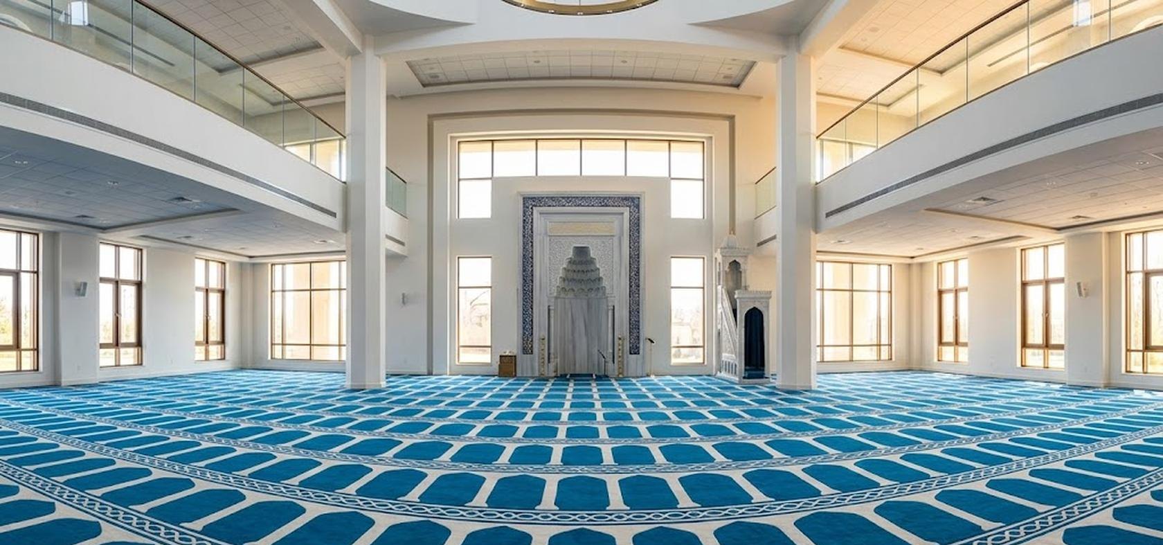 Salle de prière lumineuse d'une mosquée avec un tapis sur mesure